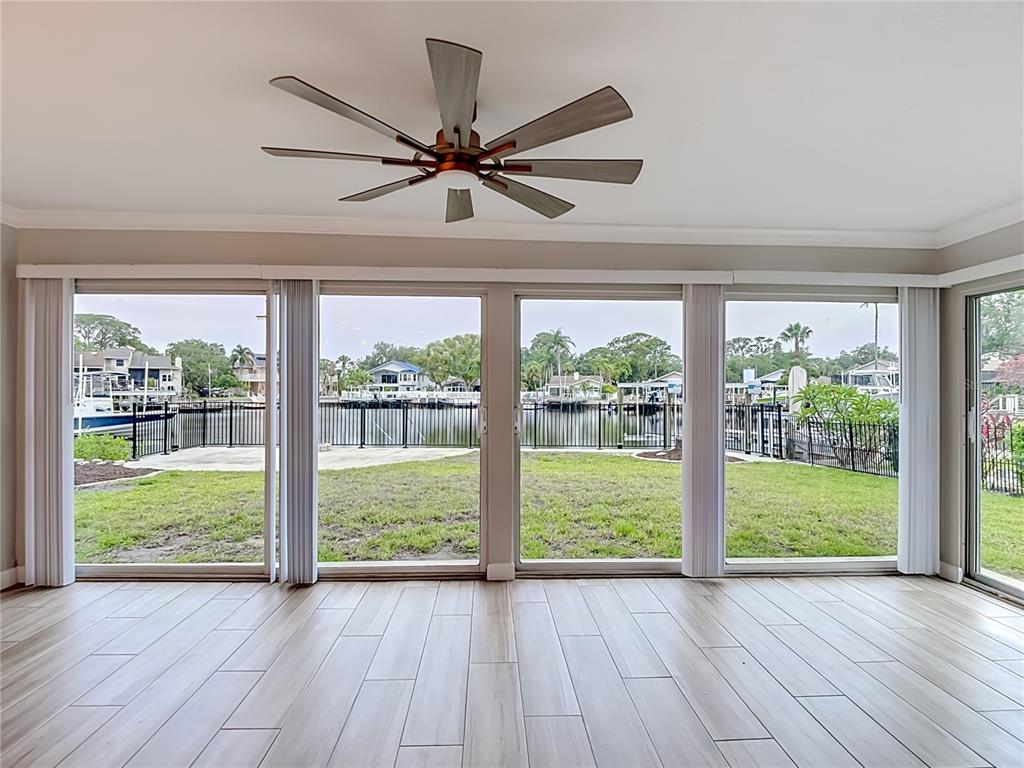 4536 Mitcher Road New Port Richey, FL 34652 - Photo 26 of 46 a view of an empty room with wooden floor and a large window with wooden floor