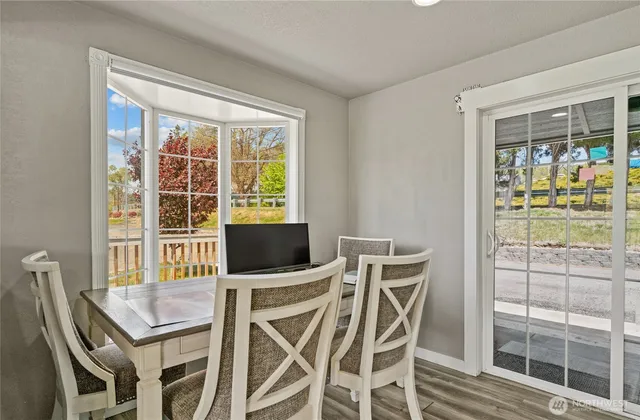 a view of a dining room with furniture and a window