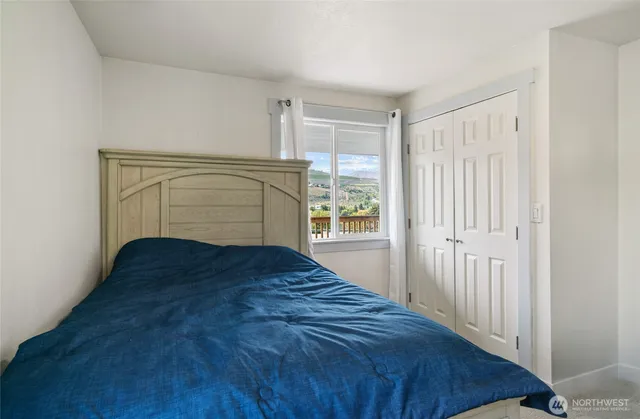 a bedroom with a bed and a window