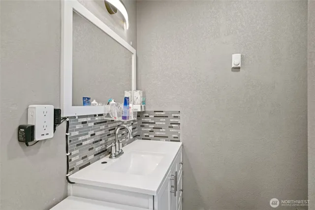 a bathroom with a sink and a mirror