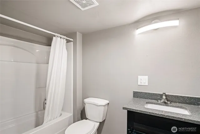 a bathroom with a sink toilet a mirror and shower