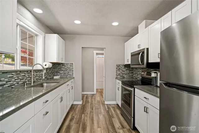 a kitchen with a sink stove and refrigerator
