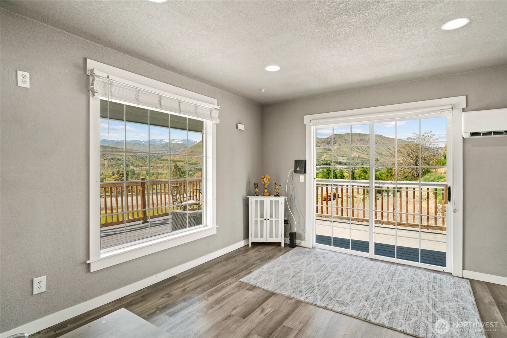 2440 Rock Island Road East Wenatchee, WA 98802 - Photo 5 of 37 a view of an empty room with wooden floor and a window