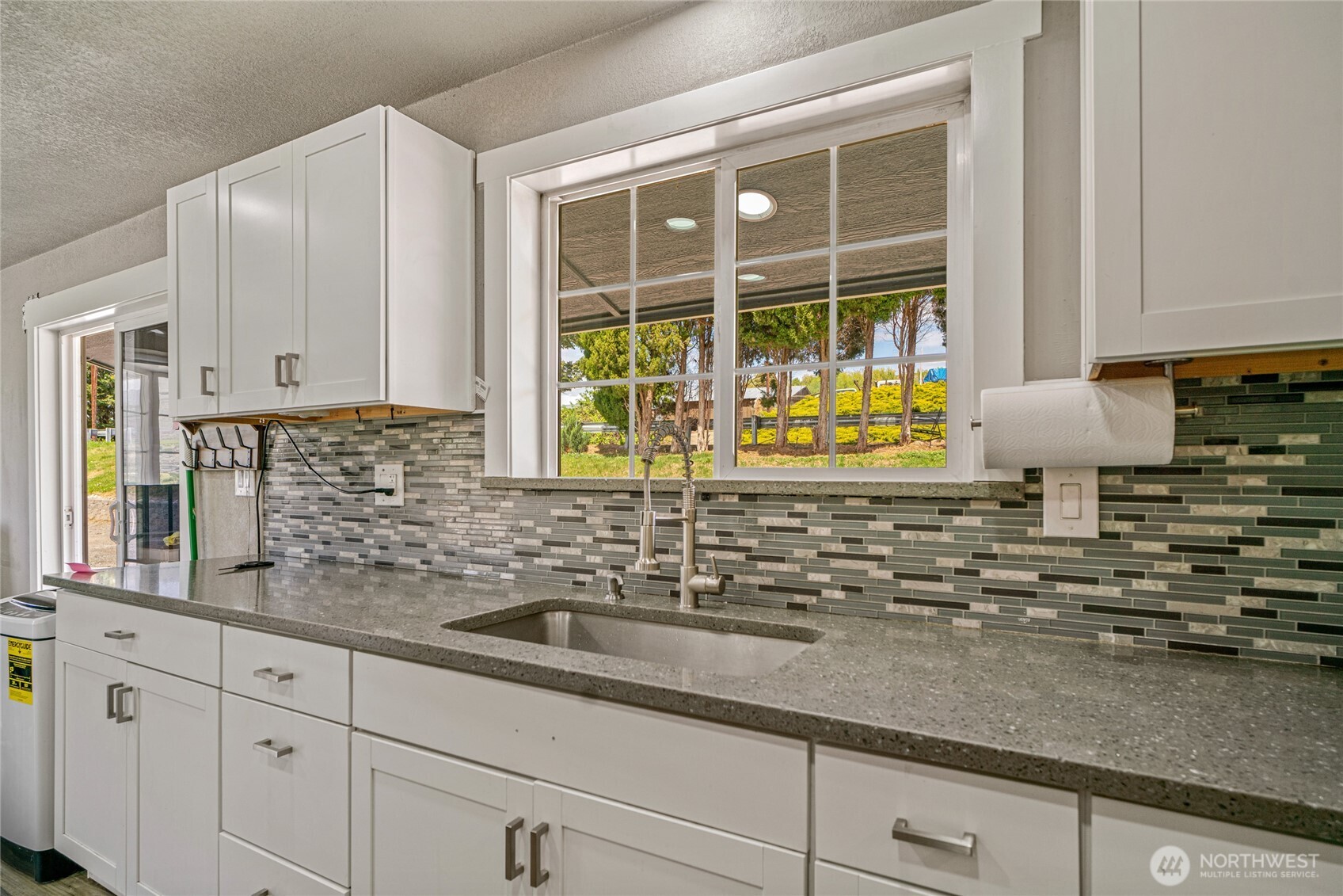 2440 Rock Island Road East Wenatchee, WA 98802 - Photo 9 of 37 a kitchen with granite countertop a sink a stove and cabinets