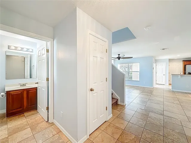 a view of room with wooden floor and ceiling fan