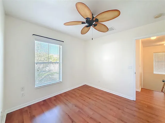 a spacious bathroom with a double vanity sink toilet mirror and bathtub