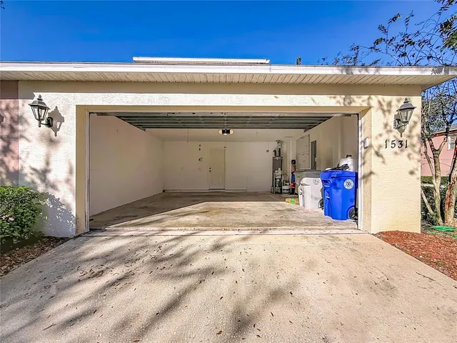 an aerial view of a house with a garden and lake view