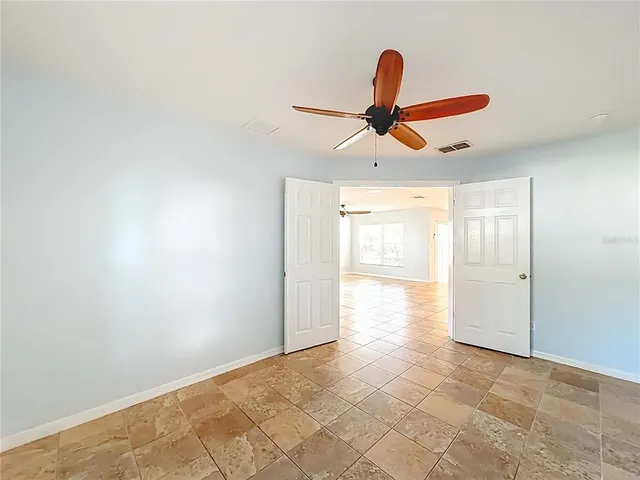 a view of a livingroom with a ceiling fan and window