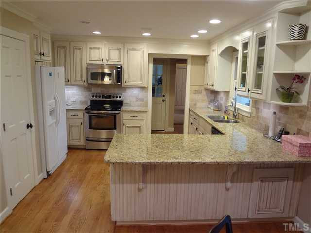 1604 Hunting Ridge Road Raleigh, NC 27615 - Photo 2 of 25 Remodeled Kithcen With Golf Course View. Granite, Hardwoods, Oil Rubbed Bronze Hardward, Designer Tile Back Splash, and Open To The Family Room. Kitchen