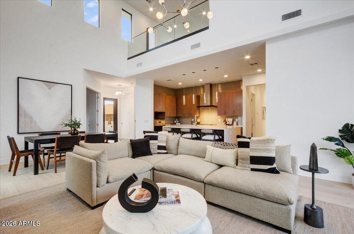 100 West Northern Avenue, Unit 6 Phoenix, AZ 85021 - Photo 3 of 26 a living room with furniture and a chandelier