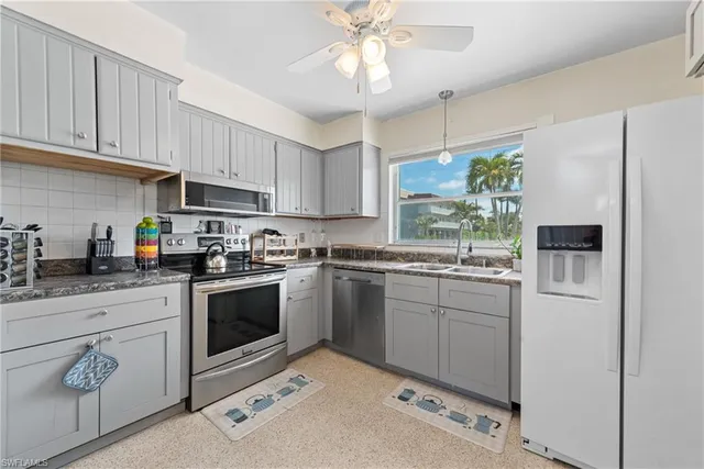 a kitchen with a white stove top oven and refrigerator