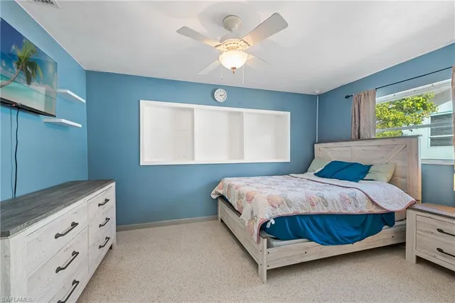 a bedroom with a bed and window