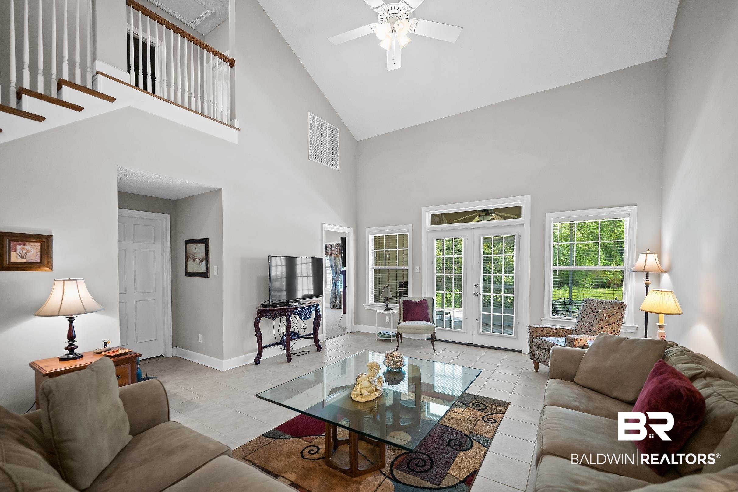 430 West Fort Morgan Road, Unit 704 Gulf Shores, AL 36542 - Photo 2 of 35 Spacious living area featuring a vaulted ceiling and tile flooring