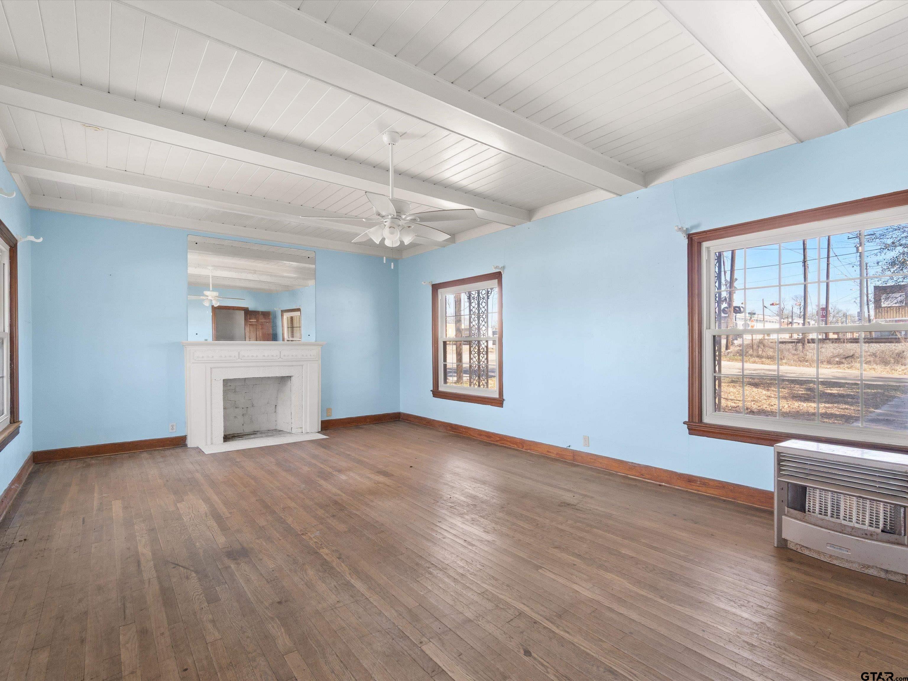 102 South Front Street Overton, TX 75684 - Photo 14 of 22 a view of an empty room with a window and wooden floor