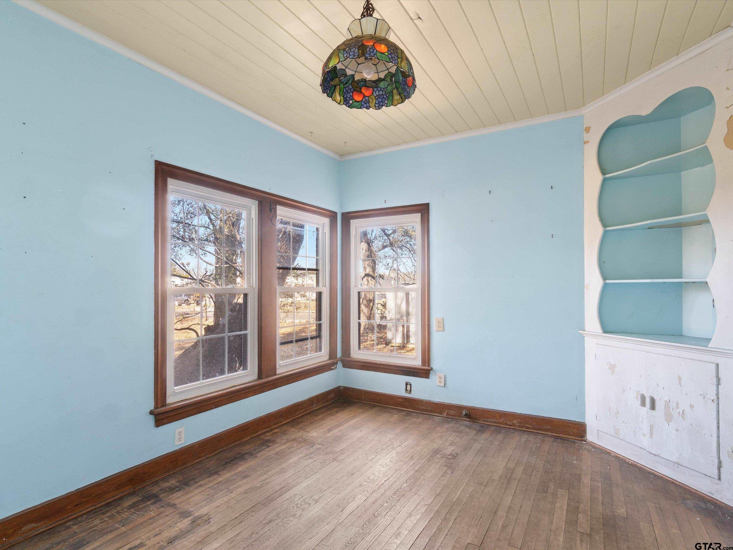 102 South Front Street Overton, TX 75684 - Photo 15 of 22 a view of an empty room with a window and wooden floor