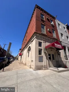 a view of a building with a door and a yard