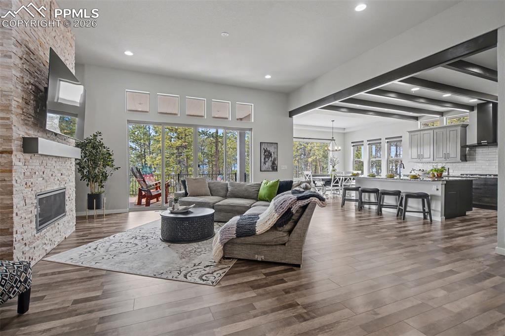 16474 Morning Rise Lane Monument, CO 80132 - Photo 12 of 49 a living room with fireplace furniture and a large window
