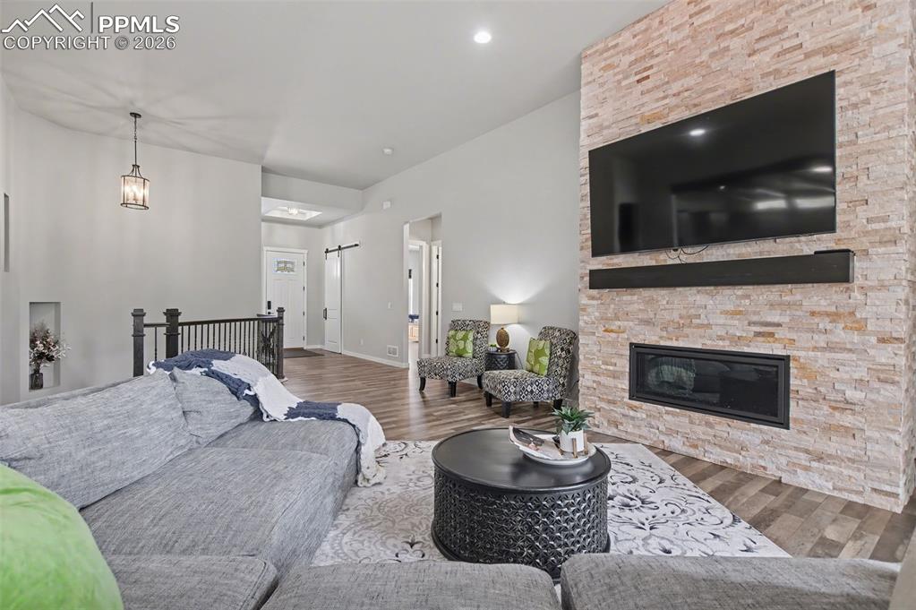 16474 Morning Rise Lane Monument, CO 80132 - Photo 13 of 49 a living room with furniture a flat screen tv and a fireplace