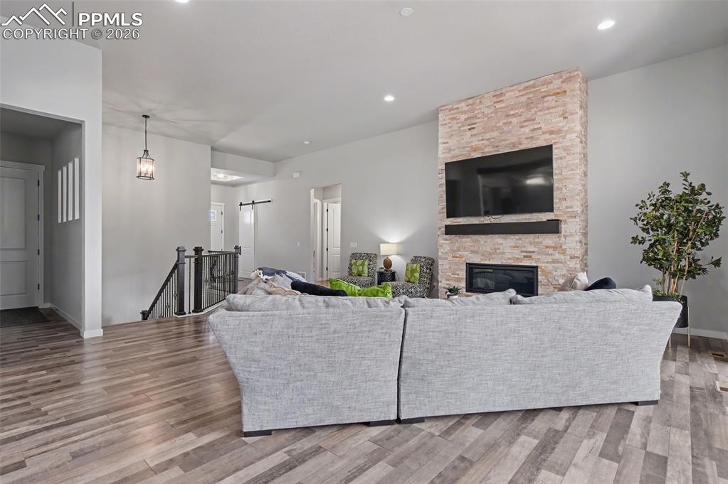 16474 Morning Rise Lane Monument, CO 80132 - Photo 15 of 49 a living room with furniture a flat screen tv and a fireplace