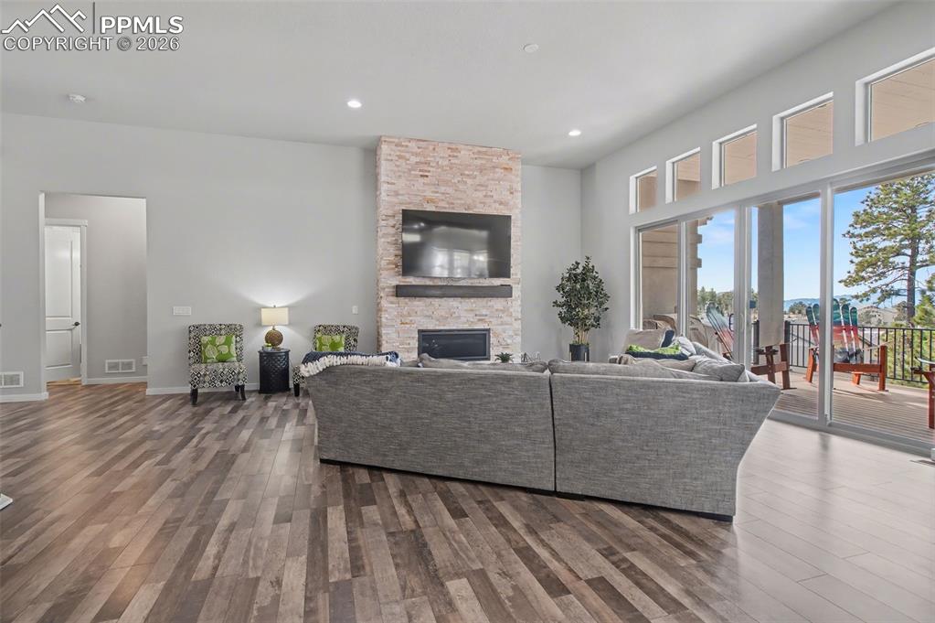 16474 Morning Rise Lane Monument, CO 80132 - Photo 16 of 49 a living room with furniture wooden floor and a fireplace