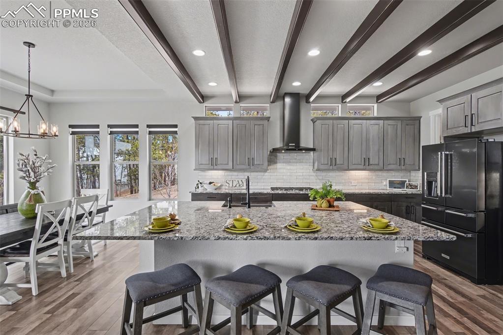 16474 Morning Rise Lane Monument, CO 80132 - Photo 20 of 49 a kitchen with stainless steel appliances granite countertop a stove a refrigerator a kitchen island a table and chairs