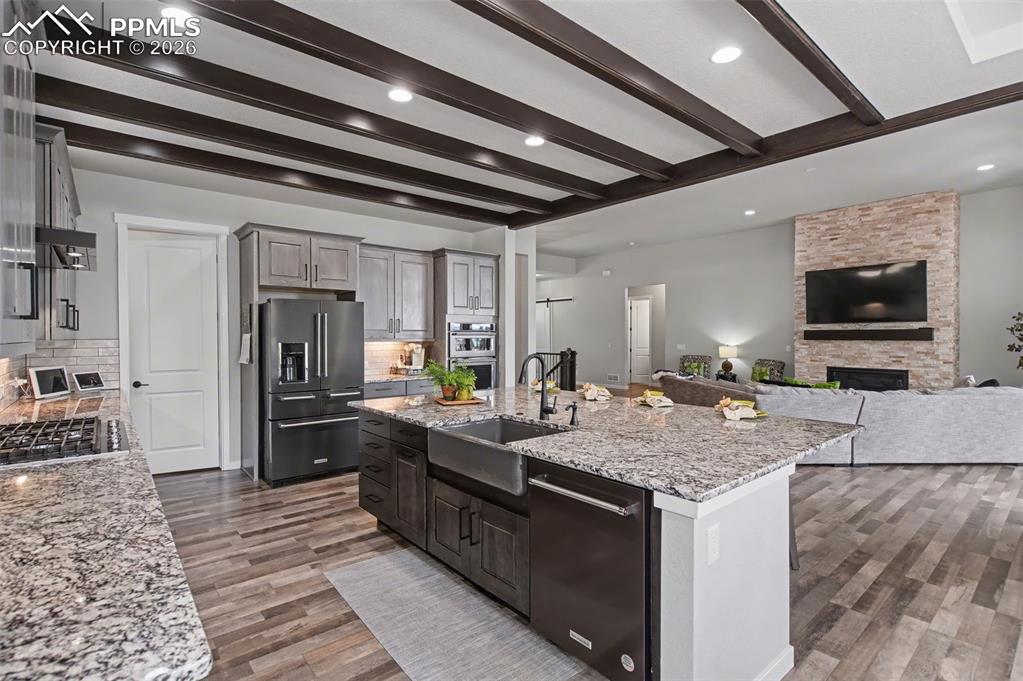 16474 Morning Rise Lane Monument, CO 80132 - Photo 22 of 49 a kitchen with stainless steel appliances granite countertop a sink stove and refrigerator