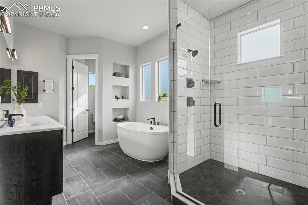 16474 Morning Rise Lane Monument, CO 80132 - Photo 26 of 49 a bathroom with a bathtub sink mirror toilet and shower