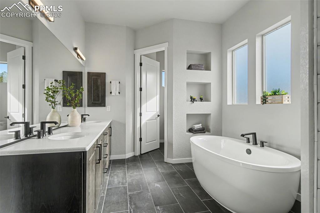 16474 Morning Rise Lane Monument, CO 80132 - Photo 27 of 49 a spacious bathroom with a bathtub sink and mirror