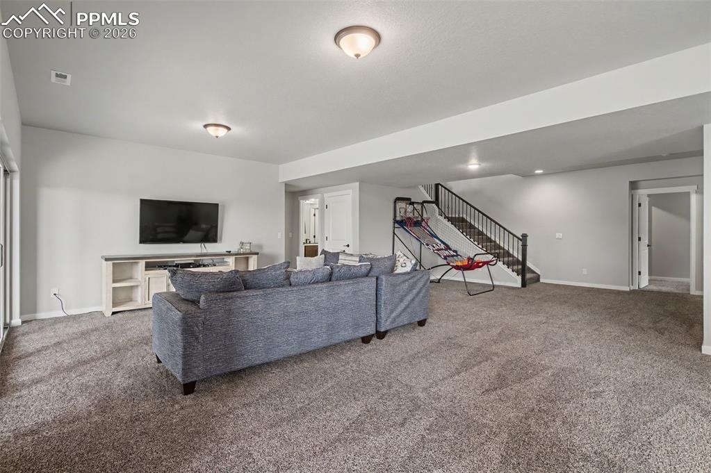 16474 Morning Rise Lane Monument, CO 80132 - Photo 33 of 49 a living room with furniture and a flat screen tv