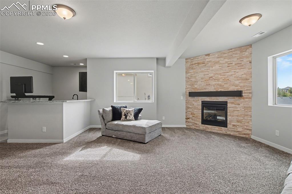 16474 Morning Rise Lane Monument, CO 80132 - Photo 35 of 49 a living room with furniture and a fireplace