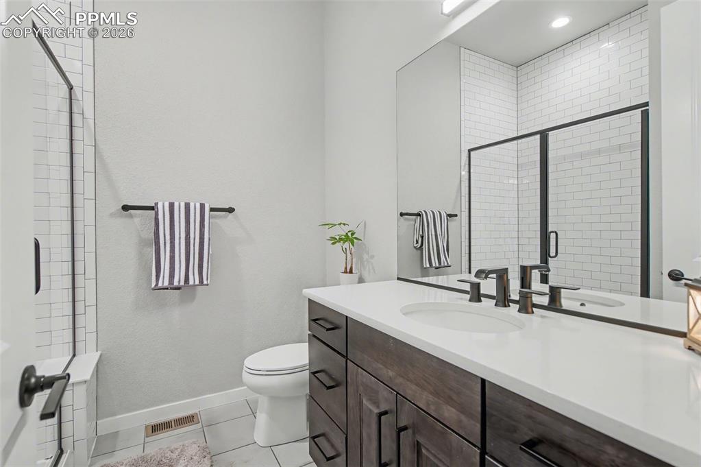 16474 Morning Rise Lane Monument, CO 80132 - Photo 39 of 49 a bathroom with a sink a toilet and mirror
