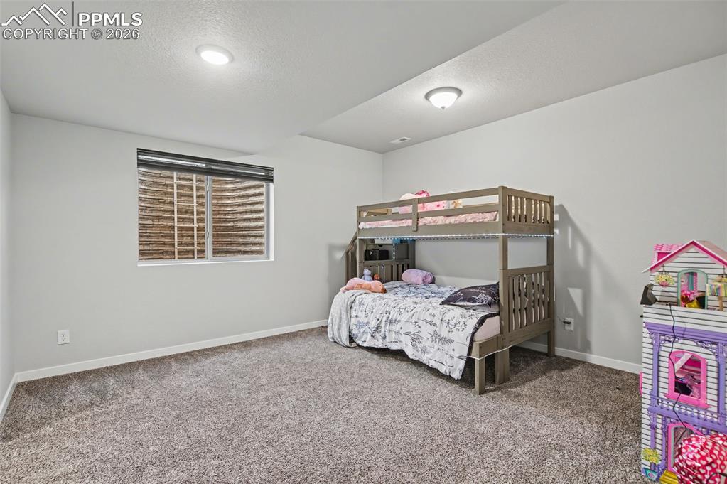 16474 Morning Rise Lane Monument, CO 80132 - Photo 40 of 49 a bedroom with a bed and a window