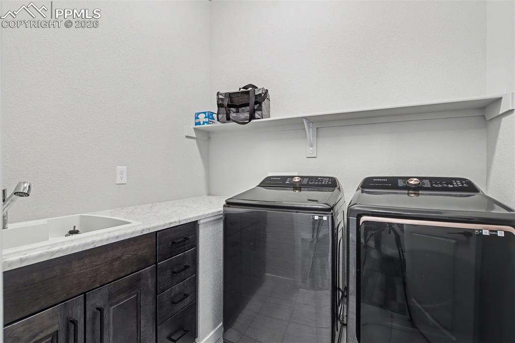 16474 Morning Rise Lane Monument, CO 80132 - Photo 41 of 49 a utility room with sink dryer and washer