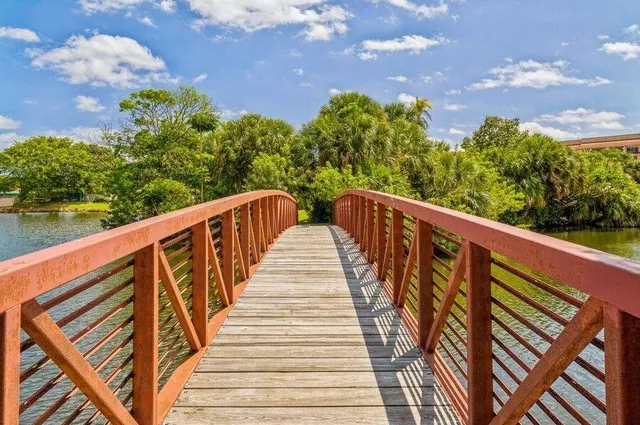 a view of balcony with wooden floor and fence