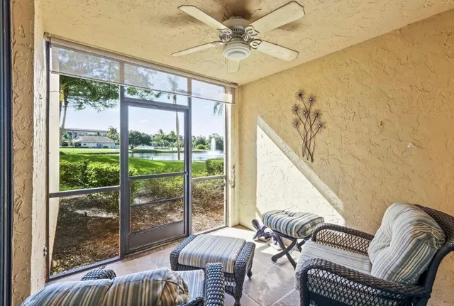 a living room with furniture and a floor to ceiling window