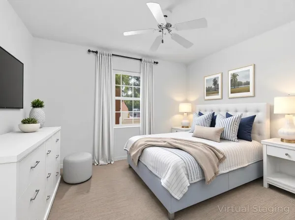 an empty room with a chandelier fan and windows