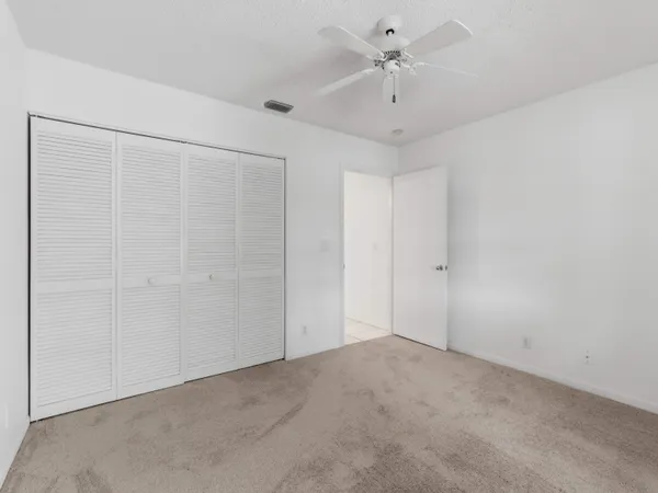 a view of an empty room with cabinet and entryway