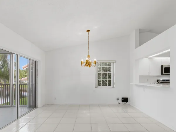 a living room with furniture potted plant and a chandelier