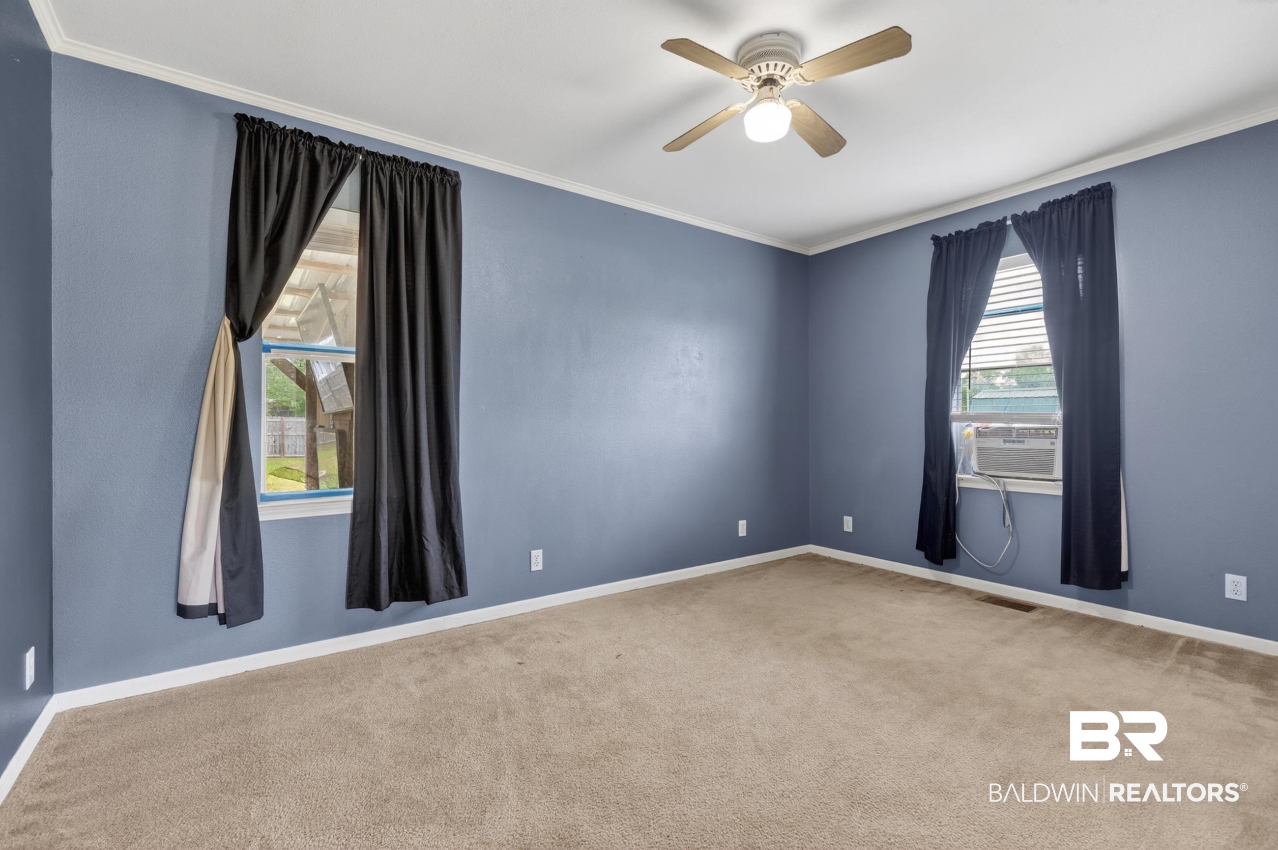 24903 Patterson Road Robertsdale, AL 36567 - Photo 55 of 57 Spacious room featuring neutral carpet flooring, blue painted walls, a ceiling fan with integrated lighting, and white trim