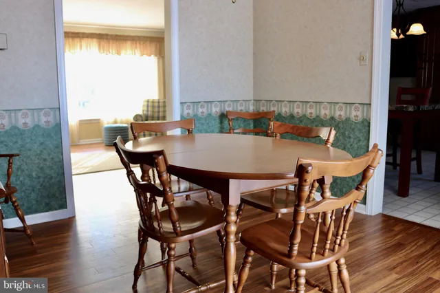 a view of a dining room with furniture and wooden floor