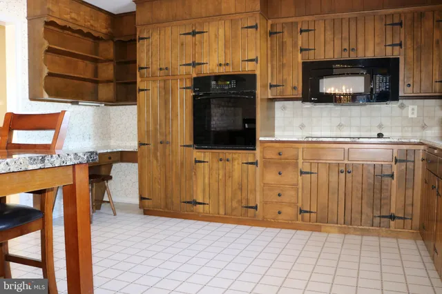 a kitchen with stainless steel appliances a stove microwave and cabinets