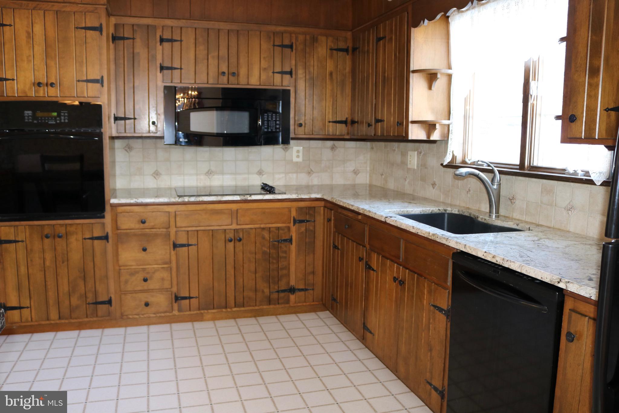 1386 Landisville Road Manheim, PA 17545 - Photo 9 of 26 a kitchen with stainless steel appliances a sink dishwasher stove and cabinets