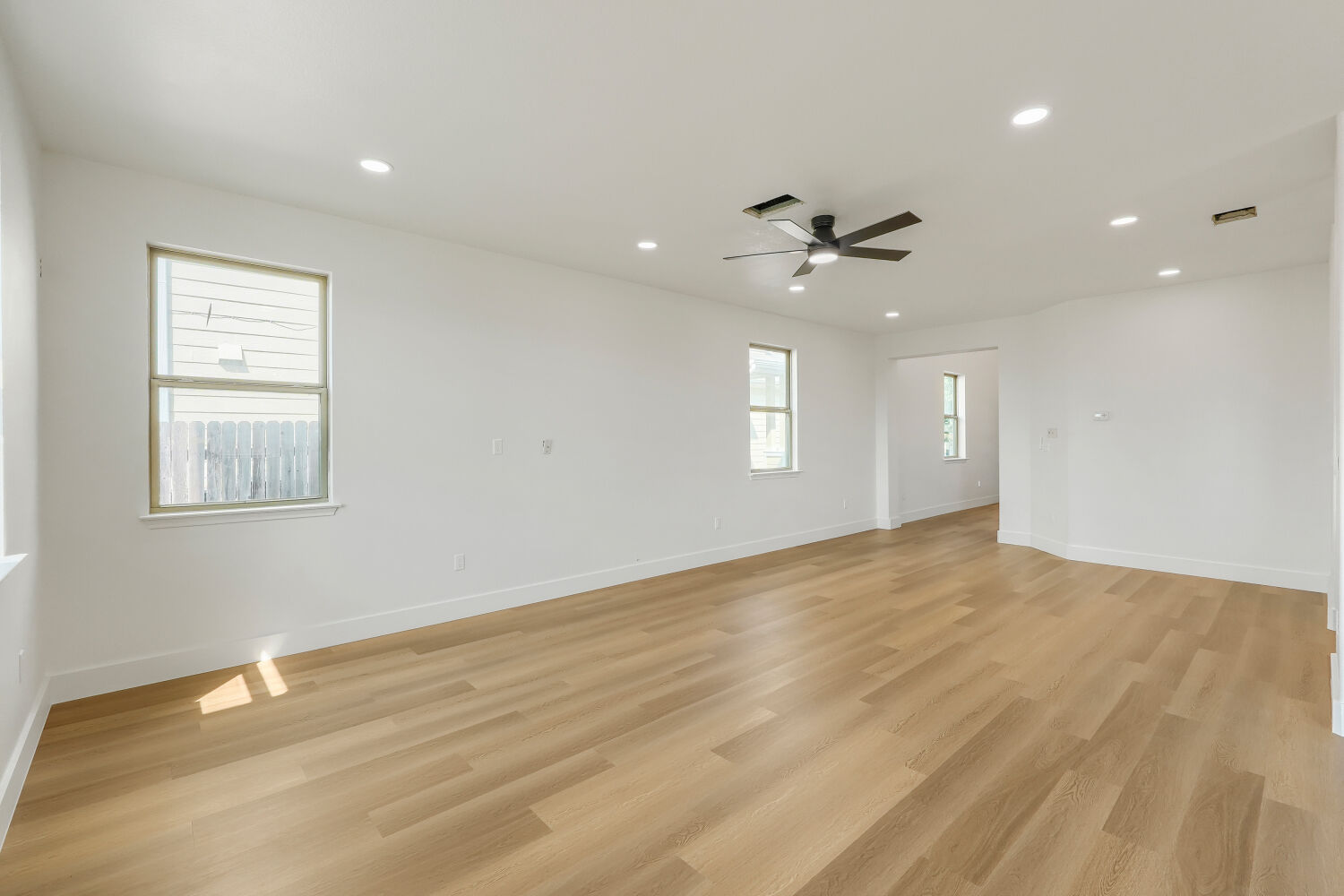 320 Triumph Road Buda, TX 78610 - Photo 5 of 22 Smooth wood floors and recessed lighting define this versatile open living space.