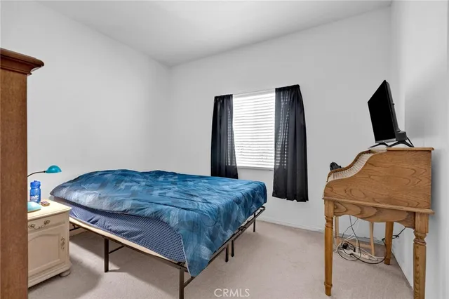 a bedroom with a bed and a chair