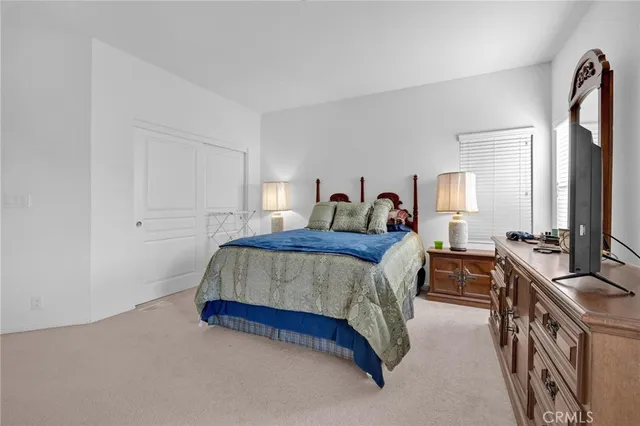 a spacious bedroom with a bed a couch and dresser