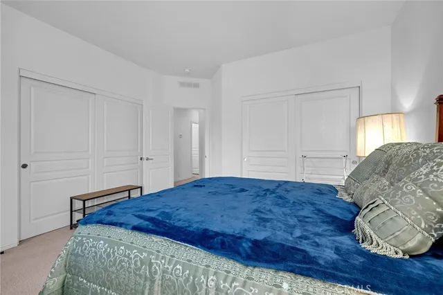 a spacious bedroom with a bed and a window