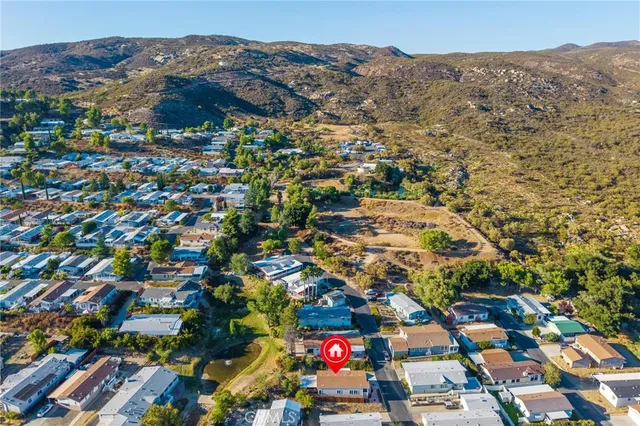 an aerial view of residential houses with outdoor space and street view