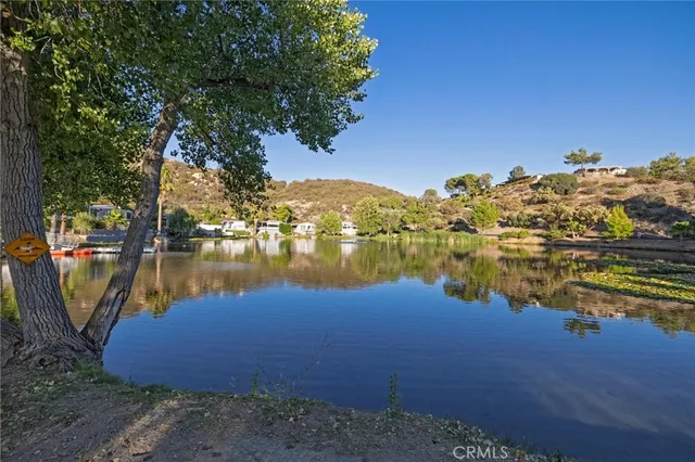 a view of a lake with houses in the back