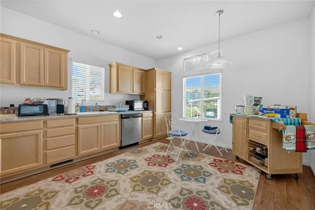 a kitchen with a refrigerator and windows