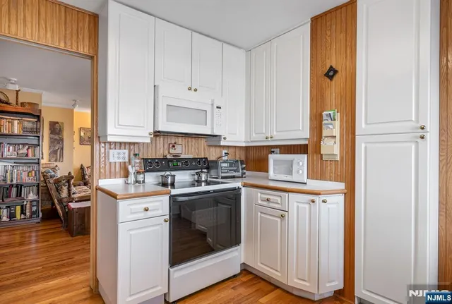 a kitchen with a stove top oven sink and cabinets